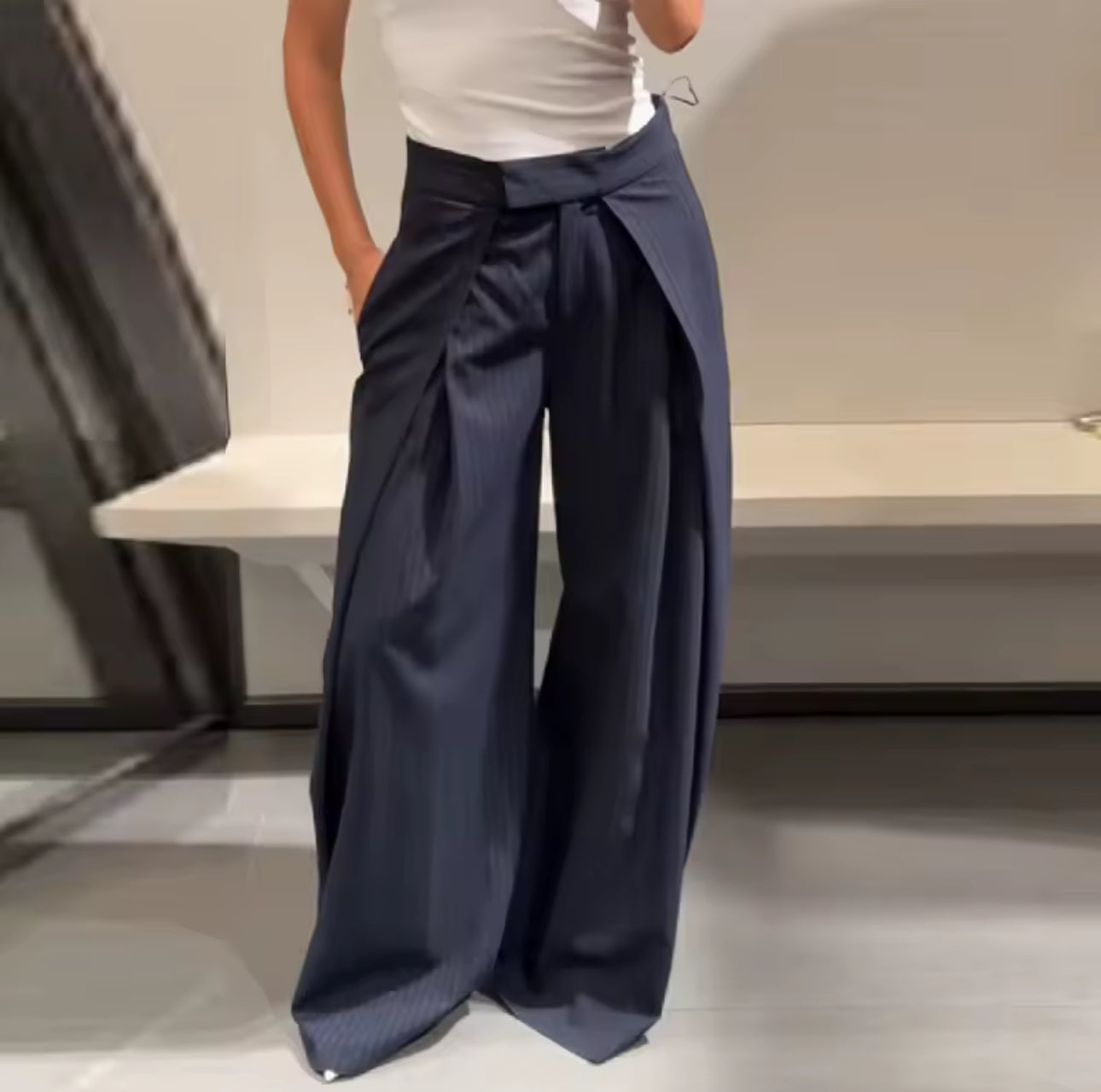 These wide-leg, pleated trousers bring immediate drama and structure to any look. Navy Blue Color