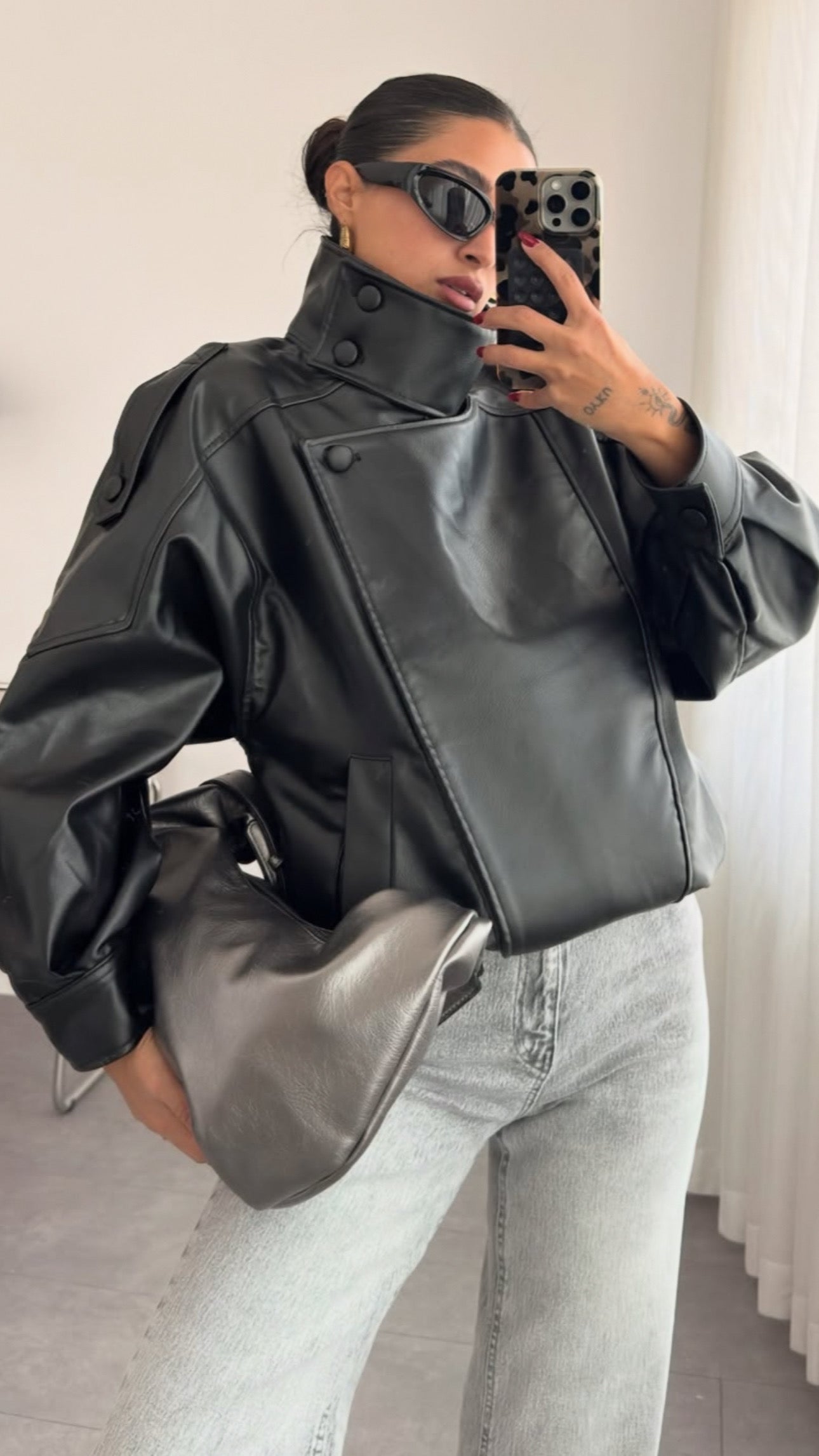 This piece reimagines the classic moto style with an oversized, contemporary edge. Crafted from sleek faux leather, this jacket is a true statement piece designed to elevate any outfit.
