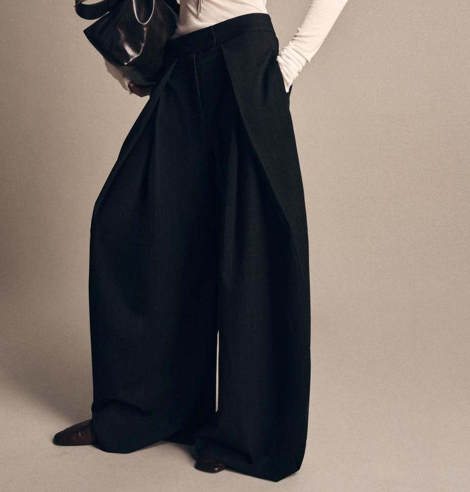 These wide-leg, pleated trousers bring immediate drama and structure to any look. - Black Color -