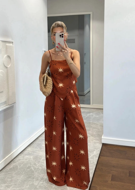 A matching set consisting of a handkerchief-hem camisole and coordinating wide-leg palazzo pants.