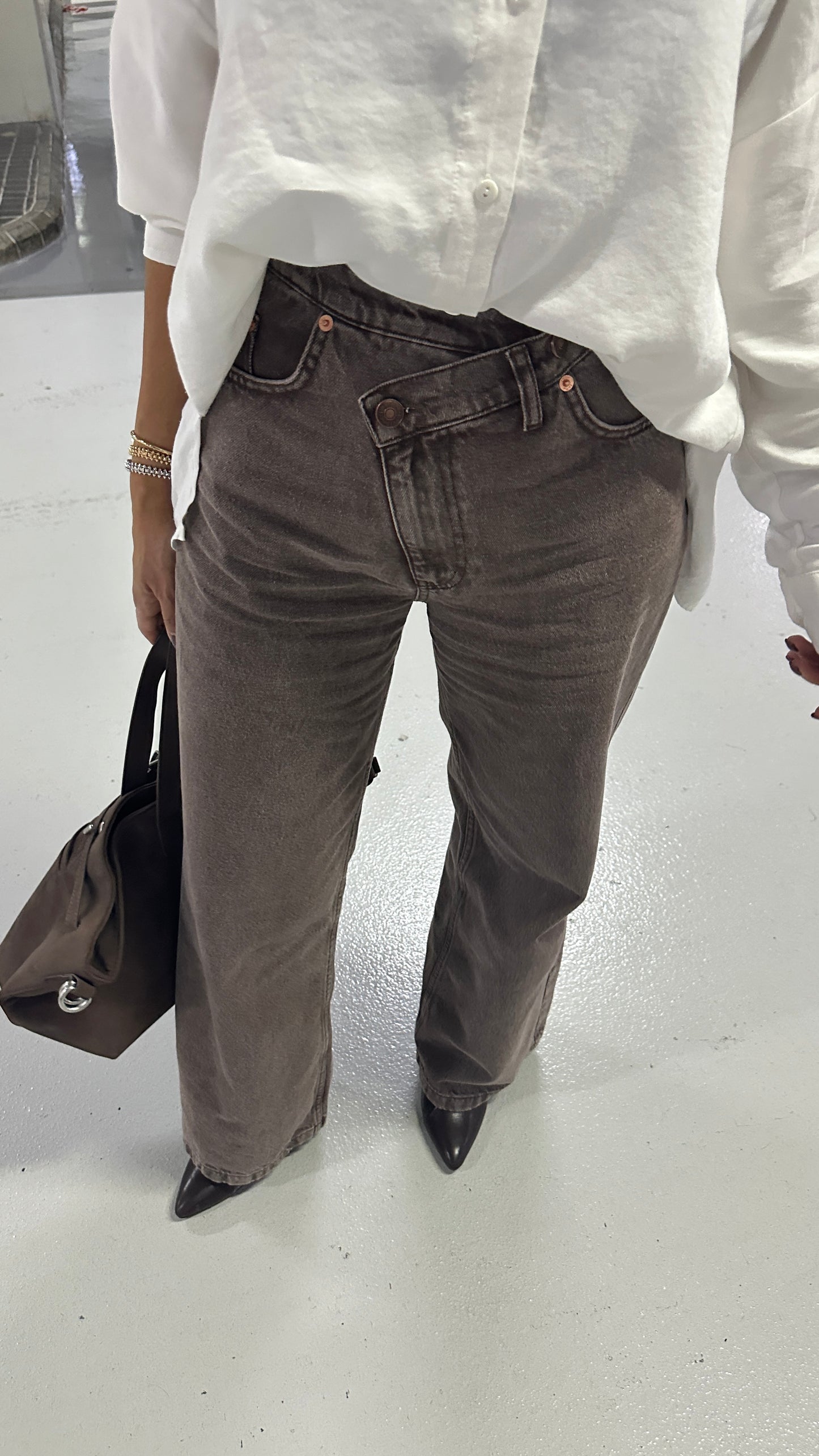 The Cross-Over Statement Jeans. Asymmetric, cross-over waist, flattering fit, premium washed brown denim, wide-leg.