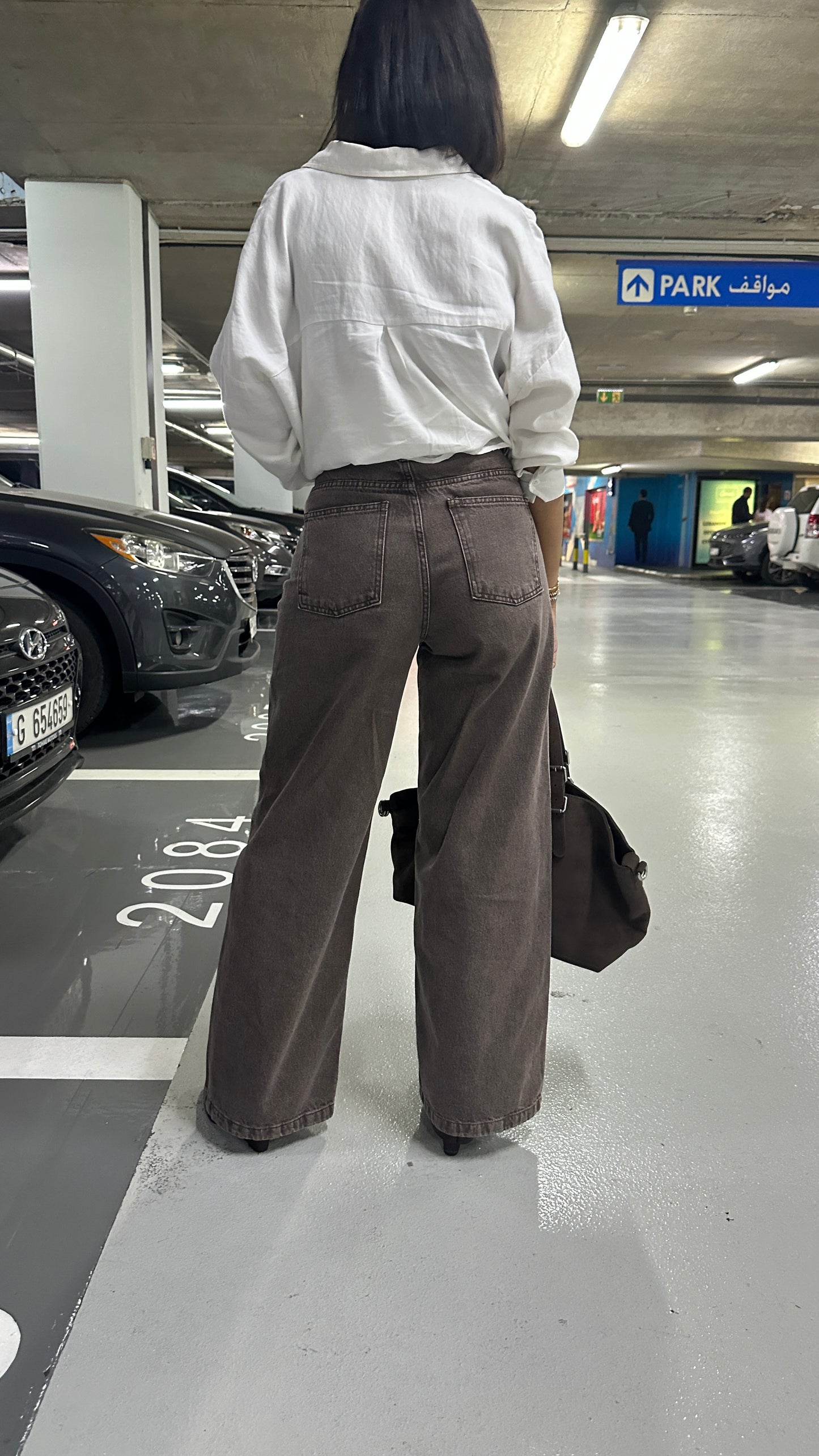 The Cross-Over Statement Jeans. Asymmetric, cross-over waist, flattering fit, premium washed brown denim, wide-leg.