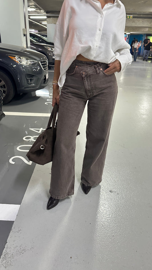The Cross-Over Statement Jeans. Asymmetric, cross-over waist, flattering fit, premium washed brown denim, wide-leg.